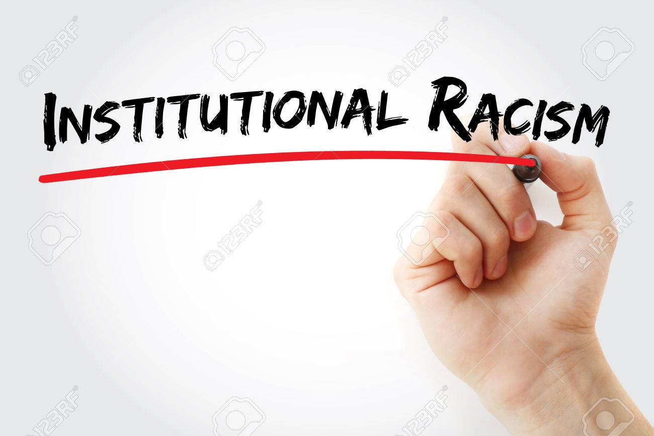 Hand writing Institutional racism with marker